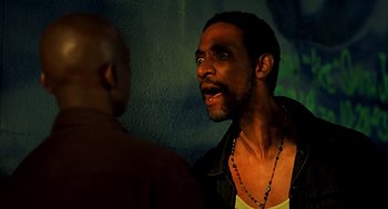 Movie still from “Clockers” (1995), directed by Spike Lee – A man with a beard is talking to another man; Close Up shot, Low angle