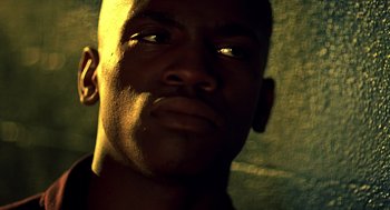 Movie still from “Clockers” (1995), directed by Spike Lee – A man's face in the sunlight; Close Up shot, Low angle