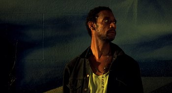 Movie still from “Clockers” (1995), directed by Spike Lee – A person wearing a jacket and a necklace; Close Up shot, Low angle