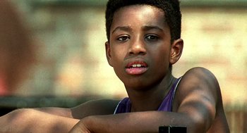 Movie still from “Clockers” (1995), directed by Spike Lee – A young man with his arms crossed; Close Up shot, Low angle