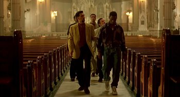 Movie still from “Clockers” (1995), directed by Spike Lee – A group of men walking down the aisle of a church; Wide shot, Low angle