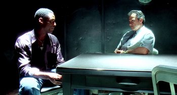 Movie still from “Clockers” (1995), directed by Spike Lee – Two men sitting at a table talking to each other; Medium shot, High angle