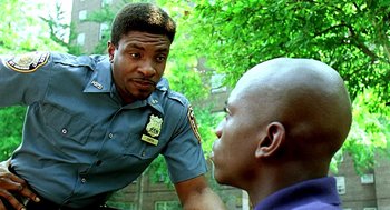 Movie still from “Clockers” (1995), directed by Spike Lee – A police officer talking to a man on a street; Close Up shot, Over the shoulder angle