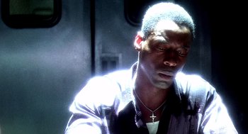 Movie still from “Clockers” (1995), directed by Spike Lee – A man with a cross on his neck and chest; Close Up shot, Low angle