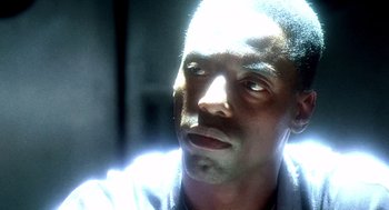 Movie still from “Clockers” (1995), directed by Spike Lee – A man's face in the light; Close Up shot, Over the shoulder angle