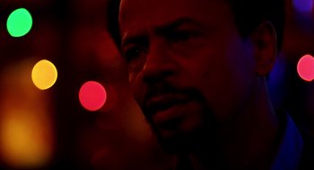 Movie still from “Clockers” (1995), directed by Spike Lee – A man's face in a dark room; Close Up shot, Over the shoulder angle