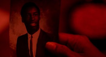 Movie still from “Clockers” (1995), directed by Spike Lee – A man wearing a suit and tie holding out his hand; Extreme Close Up shot, High angle