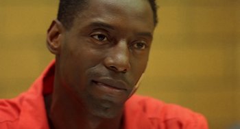 Movie still from “Clockers” (1995), directed by Spike Lee – A person wearing a red shirt; Close Up shot, Low angle