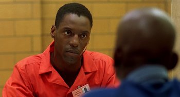 Movie still from “Clockers” (1995), directed by Spike Lee – A man in a red shirt is talking to another man in an orange shirt; Close Up shot, Over the shoulder angle