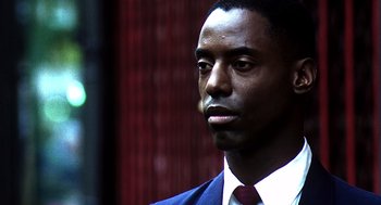 Movie still from “Clockers” (1995), directed by Spike Lee – A person wearing a suit and tie; Close Up shot, Over the shoulder angle