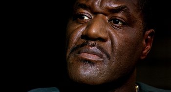 Movie still from “Clockers” (1995), directed by Spike Lee – A man's face in the dark; Close Up shot, Low angle