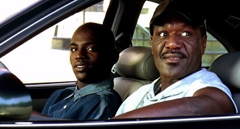 Movie still from “Clockers” (1995), directed by Spike Lee – Two men sitting in the back seat of a car; Close Up shot, Low angle