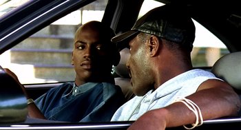 Movie still from “Clockers” (1995), directed by Spike Lee – Two men sitting in the back seat of a car; Close Up shot, Over the shoulder angle