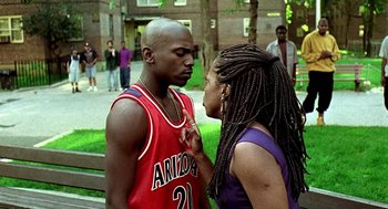 Movie still from “Clockers” (1995), directed by Spike Lee – A man and a woman face to face in a park; Medium shot, Over the shoulder angle