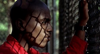 Movie still from “Clockers” (1995), directed by Spike Lee – A person wearing a red shirt; Close Up shot, Low angle
