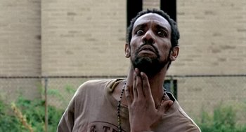 Movie still from “Clockers” (1995), directed by Spike Lee – A man with a beard is looking up at the sky; Close Up shot, Low angle