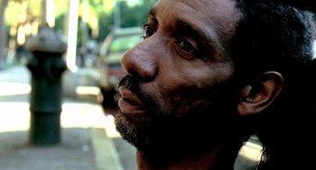 Movie still from “Clockers” (1995), directed by Spike Lee – A person with a beard looking to his left; Close Up shot, Low angle