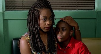 Movie still from “Clockers” (1995), directed by Spike Lee – A woman and a young boy posing for a picture; Close Up shot, High angle