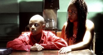 Movie still from “Clockers” (1995), directed by Spike Lee – A man and a woman sitting at a table in front of each other; Close Up shot, Low angle