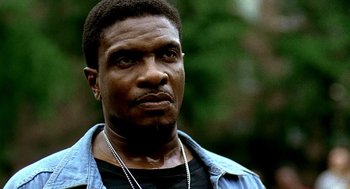 Movie still from “Clockers” (1995), directed by Spike Lee – A person wearing a shirt and a necklace; Close Up shot, Low angle