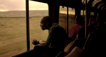 Movie still from “Clockers” (1995), directed by Spike Lee – A man sitting on a train looking out the window; Medium shot, Low angle