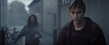 Movie still from “Death Note” (2017), directed by Adam Wingard – A man and a woman walking down a street; Close Up shot, Over the shoulder angle