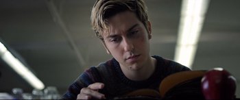 Movie still from “Death Note” (2017), directed by Adam Wingard – A young man is looking down at a book; Close Up shot, Low angle