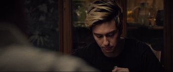 Movie still from “Death Note” (2017), directed by Adam Wingard – A man with blonde hair is looking down at a book; Close Up shot, Over the shoulder angle