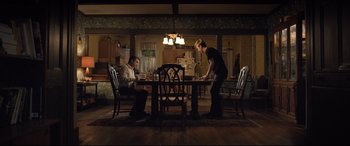 Movie still from “Death Note” (2017), directed by Adam Wingard – Two people sitting at a dinner table in a dark room; Wide shot, High angle