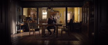 Movie still from “Death Note” (2017), directed by Adam Wingard – A man sitting at a table in front of a phone; Wide shot, Low angle