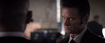 Movie still from “Death Note” (2017), directed by Adam Wingard – A person wearing a suit and tie; Close Up shot, Over the shoulder angle