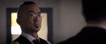 Movie still from “Death Note” (2017), directed by Adam Wingard – A person wearing glasses and a tie; Close Up shot, Over the shoulder angle