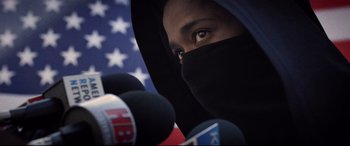 Movie still from “Death Note” (2017), directed by Adam Wingard – A person wearing a black face mask and a black hood; Close Up shot, Low angle