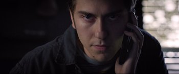 Movie still from “Death Note” (2017), directed by Adam Wingard – A person talking on a cell phone; Close Up shot, Low angle