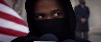 Movie still from “Death Note” (2017), directed by Adam Wingard – A man with a black scarf covering his face; Close Up shot, Over the shoulder angle
