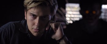 Movie still from “Death Note” (2017), directed by Adam Wingard – A young man talking on a cell phone in the dark; Close Up shot, Low angle