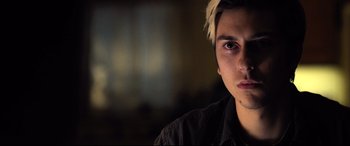 Movie still from “Death Note” (2017), directed by Adam Wingard – A young man with blonde hair stares into the camera; Close Up shot, Over the shoulder angle