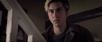 Movie still from “Death Note” (2017), directed by Adam Wingard – A young man with blonde hair looking at the camera; Close Up shot, Over the shoulder angle