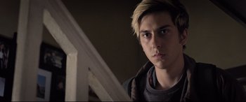 Movie still from “Death Note” (2017), directed by Adam Wingard – A young man with blonde hair is looking at the camera; Close Up shot, Over the shoulder angle