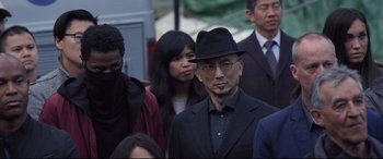 Movie still from “Death Note” (2017), directed by Adam Wingard – A group of people standing next to each other wearing hats; Close Up shot, Over the shoulder angle