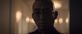 Movie still from “Death Note” (2017), directed by Adam Wingard – A person wearing glasses; Close Up shot, Low angle