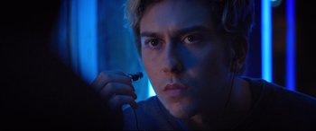 Movie still from “Death Note” (2017), directed by Adam Wingard – A young man holding a pair of headphones in his hands; Close Up shot, Over the shoulder angle