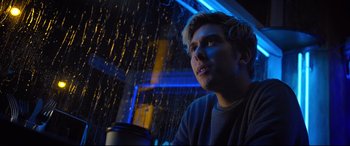 Movie still from “Death Note” (2017), directed by Adam Wingard – A man sitting in front of a window at night; Close Up shot, Low angle