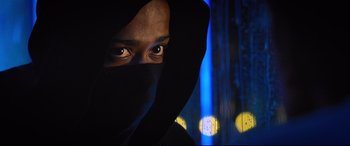 Movie still from “Death Note” (2017), directed by Adam Wingard – A man wearing a black hood and a black mask; Close Up shot, Low angle