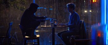 Movie still from “Death Note” (2017), directed by Adam Wingard – Two people sitting at a table in a restaurant; Wide shot, Low angle