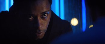 Movie still from “Death Note” (2017), directed by Adam Wingard – A man's face in a dark room; Close Up shot, Over the shoulder angle