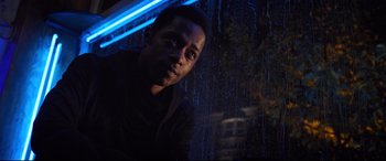 Movie still from “Death Note” (2017), directed by Adam Wingard – A man standing in front of a window in the rain; Close Up shot, Low angle