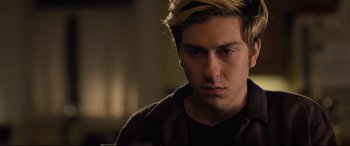 Movie still from “Death Note” (2017), directed by Adam Wingard – A young man with blonde hair stares into the camera; Close Up shot, Over the shoulder angle