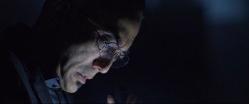 Movie still from “Death Note” (2017), directed by Adam Wingard – A person wearing glasses looking at a cell phone; Close Up shot, Low angle
