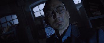 Movie still from “Death Note” (2017), directed by Adam Wingard – A person wearing glasses and a blue shirt; Close Up shot, Low angle